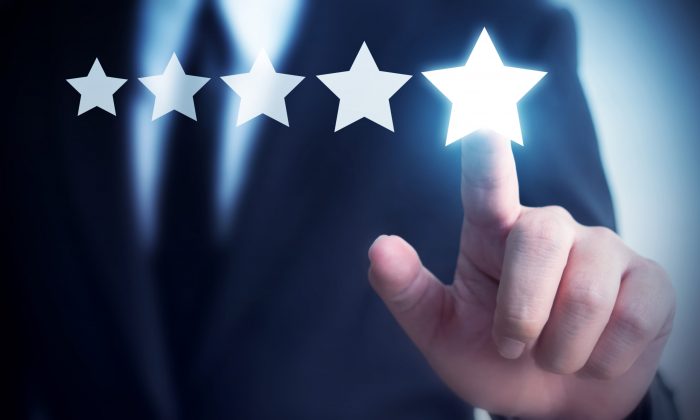 Businessman hand touching five star symbol to increase rating of company concept, Copy space background for your title Businessman hand touching five star symbol to increase rating of company concept, Copy space background for your title